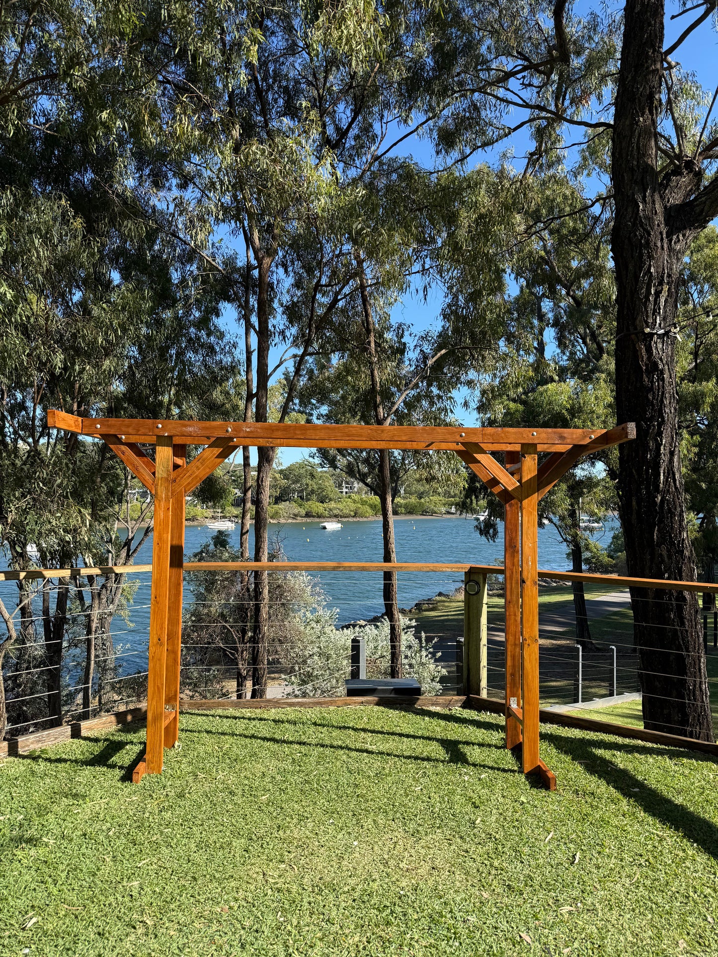 Custom made by RVH, polished timber four post double arbor. Weddings Rockhampton. Rockhampton Vintage Hire