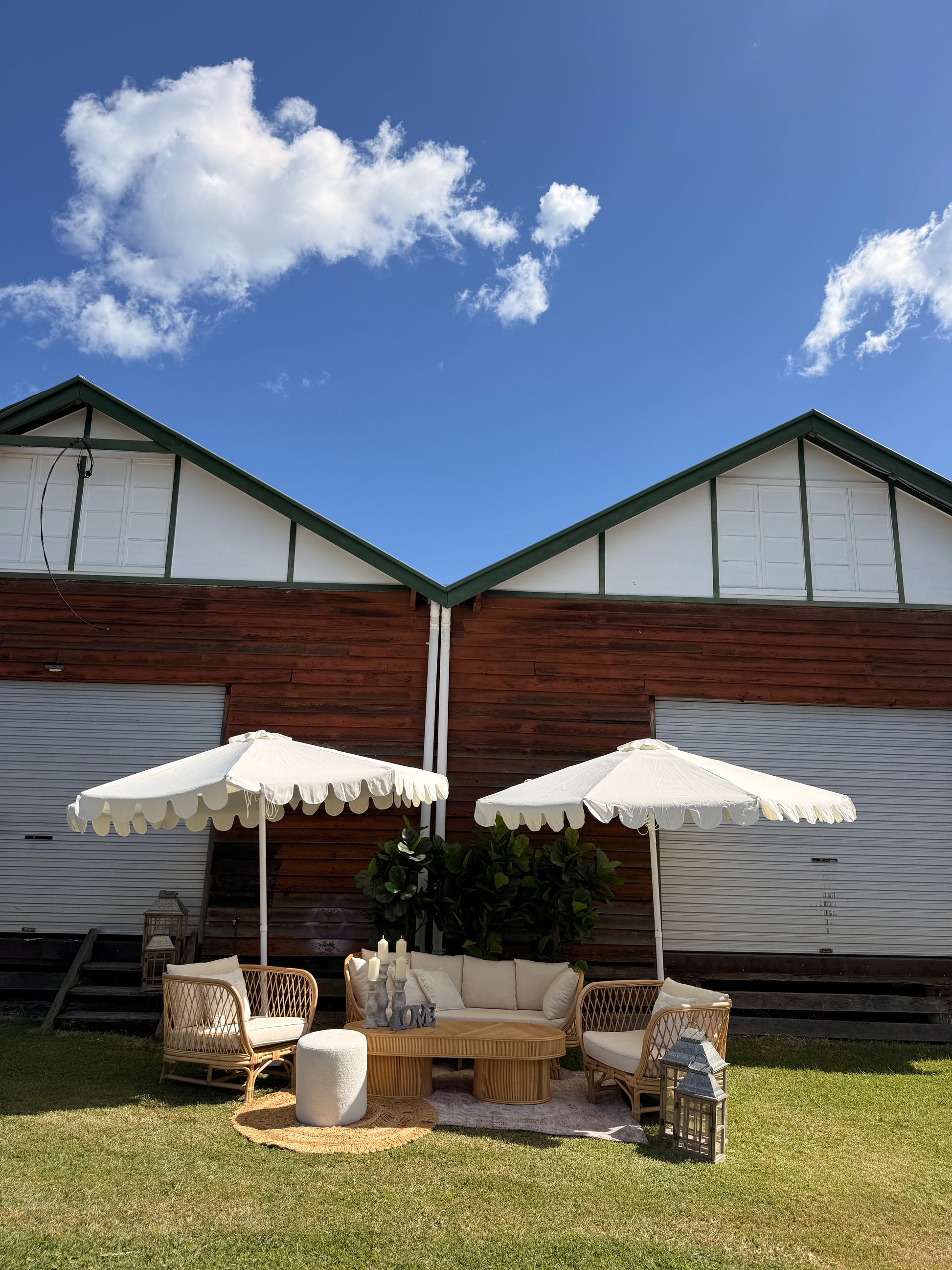 Outdoor Rattan 3-Seater Lounge, armchair setting with umbrellas for hire Available weddings, events & party hire Rockhampton Vintage Hire