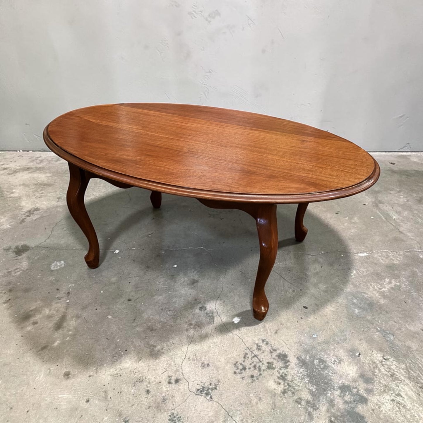 Vintage oval timber coffee table with polished timber top, mix and match with our vintage furniture. Rockhampton Vintage Hire