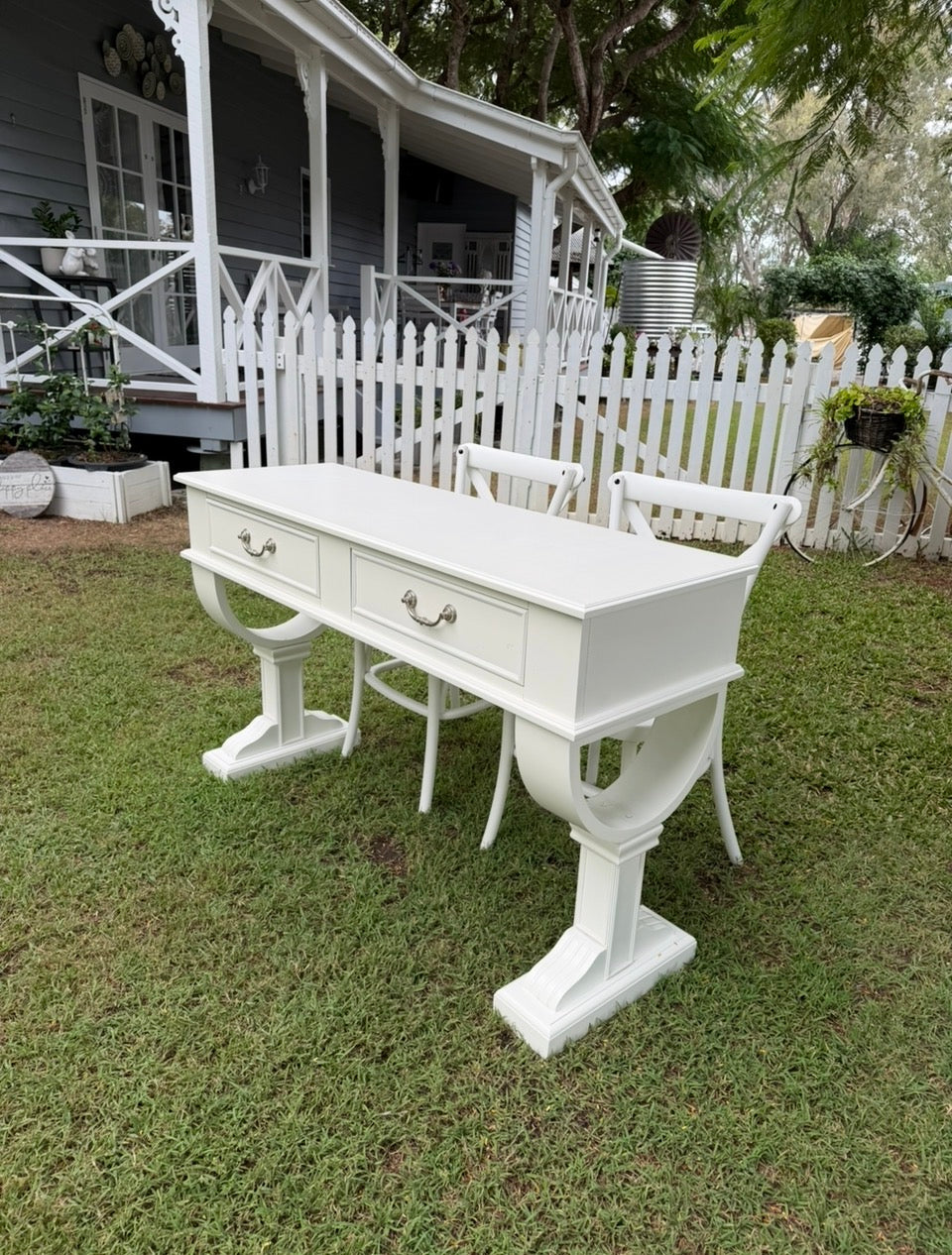 French Provincial or Hamptons-style white signing table with impressive pedestal legs & drawers. Pair with white cross back chairs.  Wedding, event & party hire.  Rockhampton Vintage Hire 